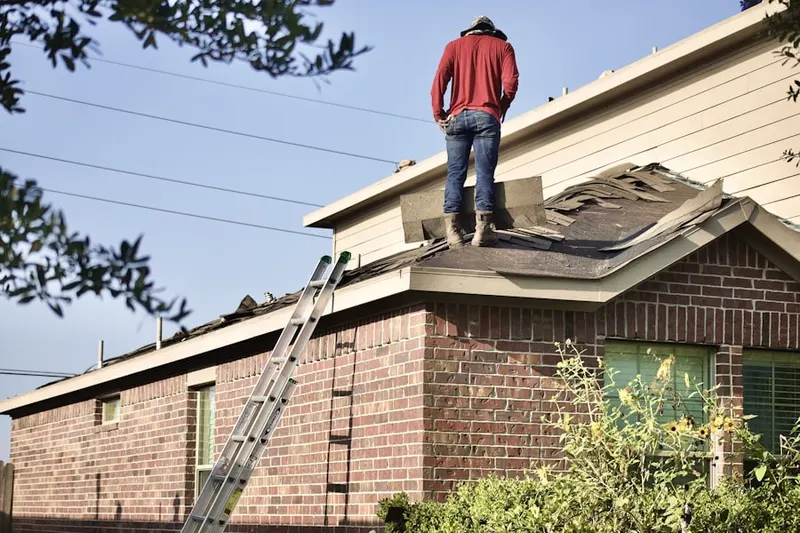 Professional roofer working on a residential roof in Prichard